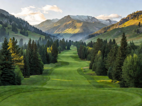 Lush championship golf course fairway winding through mountain valley heights at St. Eugene Resort